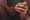 African American man with head in hand looking down and depressed
